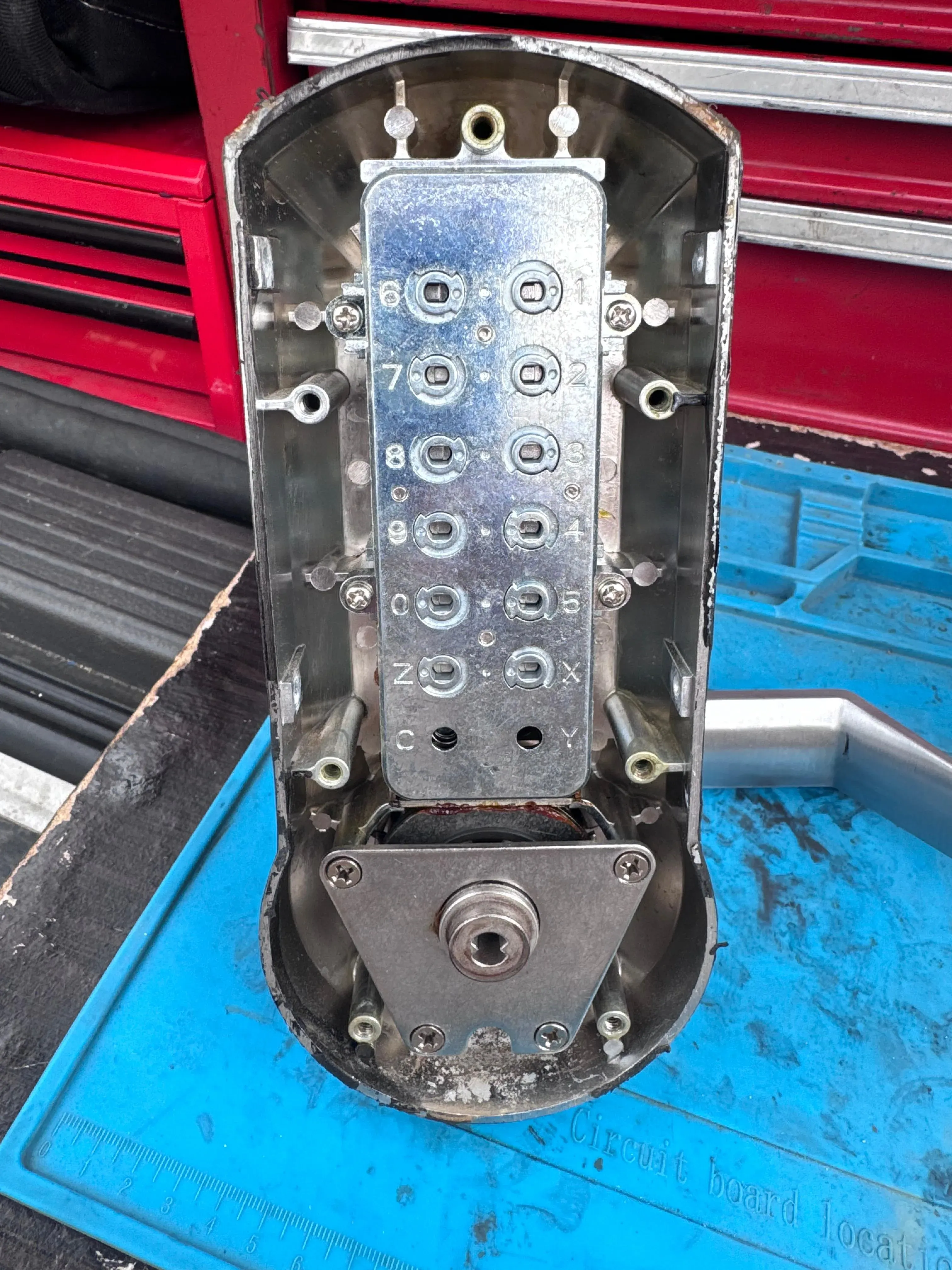 Disassembled access control lock components laid out on a service bench in Texas