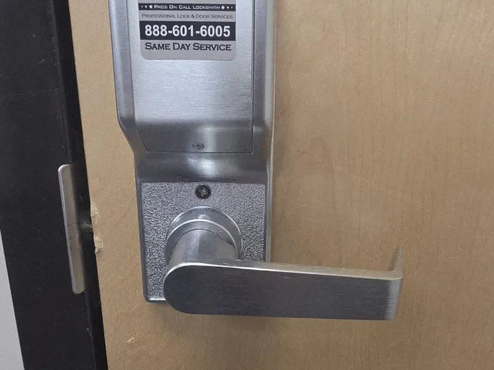 Pros On Call technician installing a smart card reader on a server room door at a Texas commercial facility