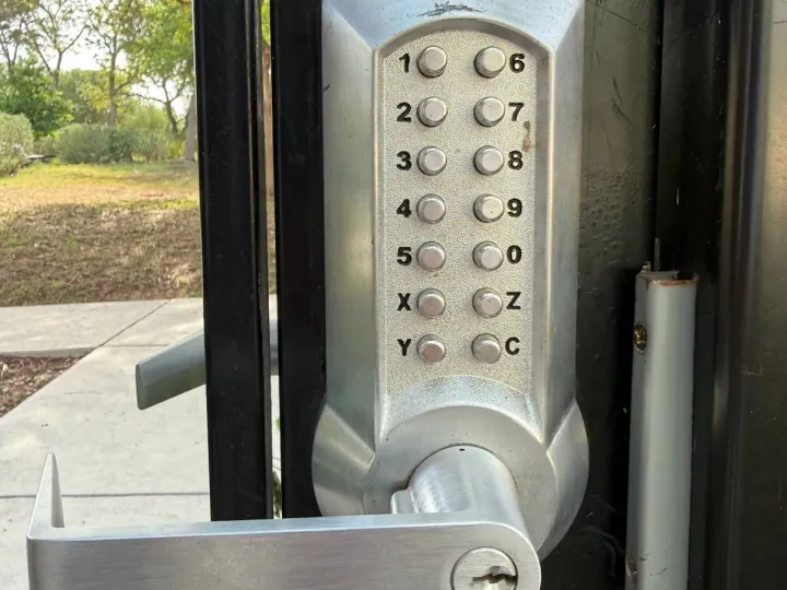 Mechanical keypad gate entry system installed by Pros On Call in Texas, representative of the gate hardware serviced alongside LiftMaster operators.