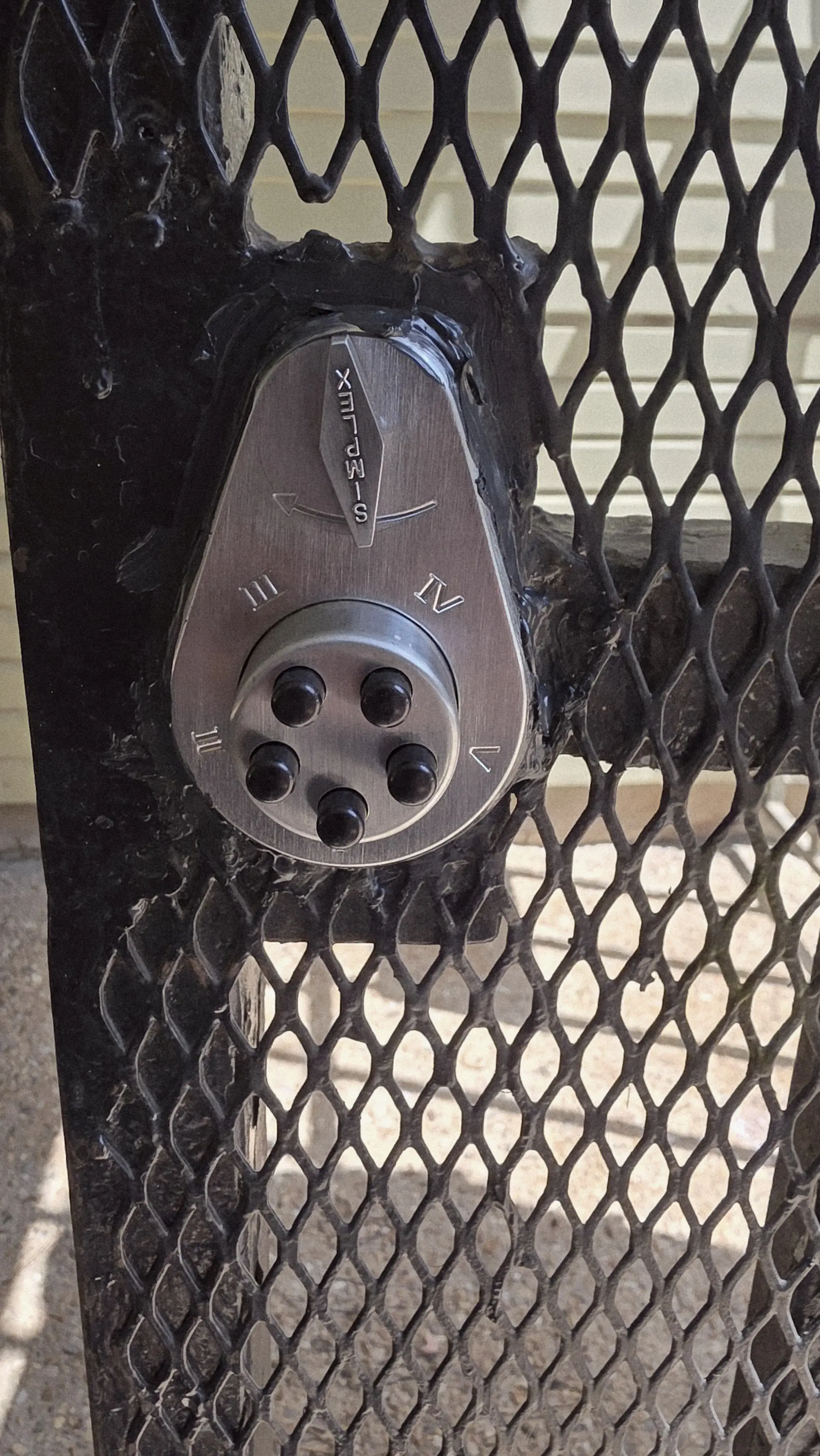 Iron driveway gate with a Simplex pushbutton keypad entry system, installed by Pros On Call in Texas