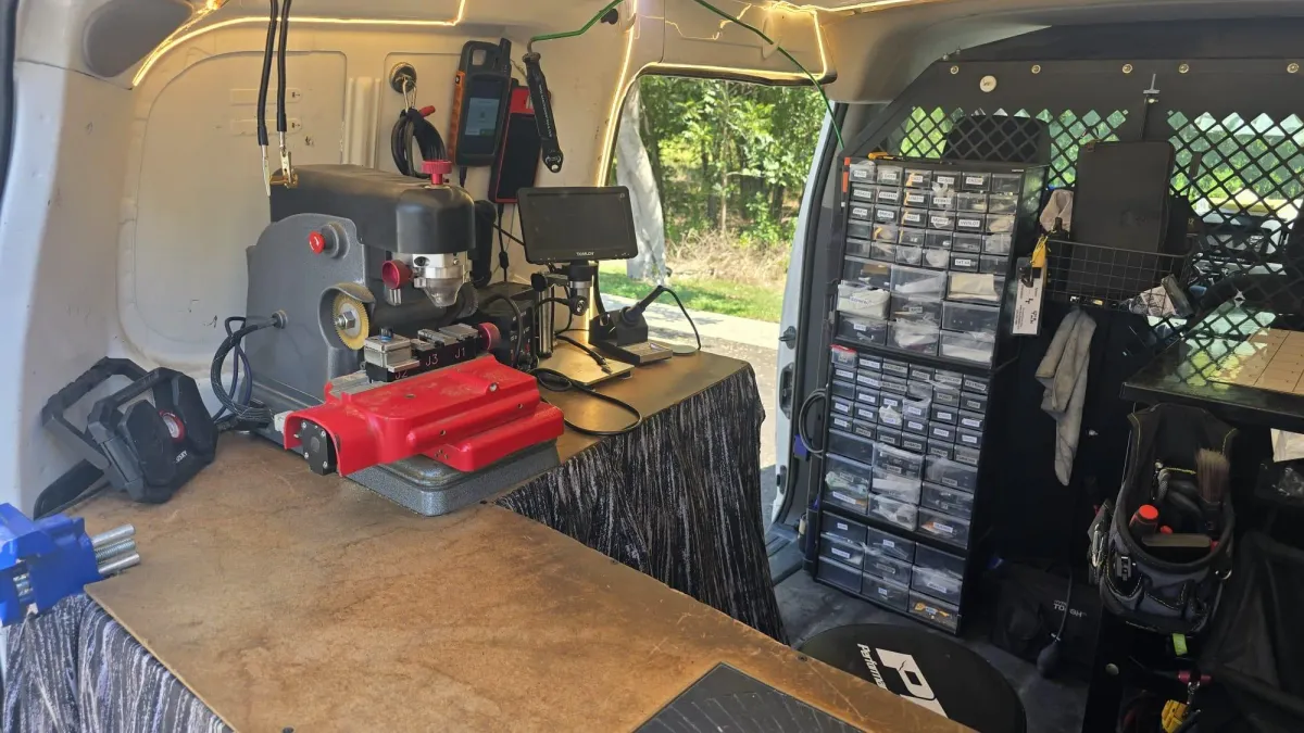 Pros On Call locksmith workstation inside a service van with key cutting machine and microscope equipment