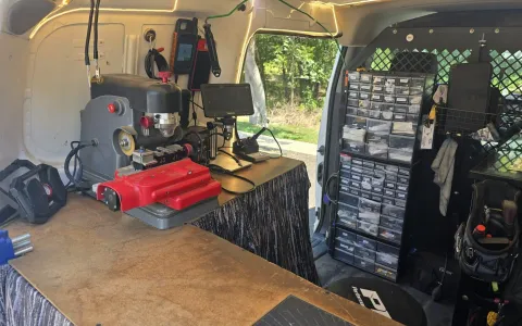 Pros On Call locksmith workstation inside a service van with key cutting machine and microscope equipment
