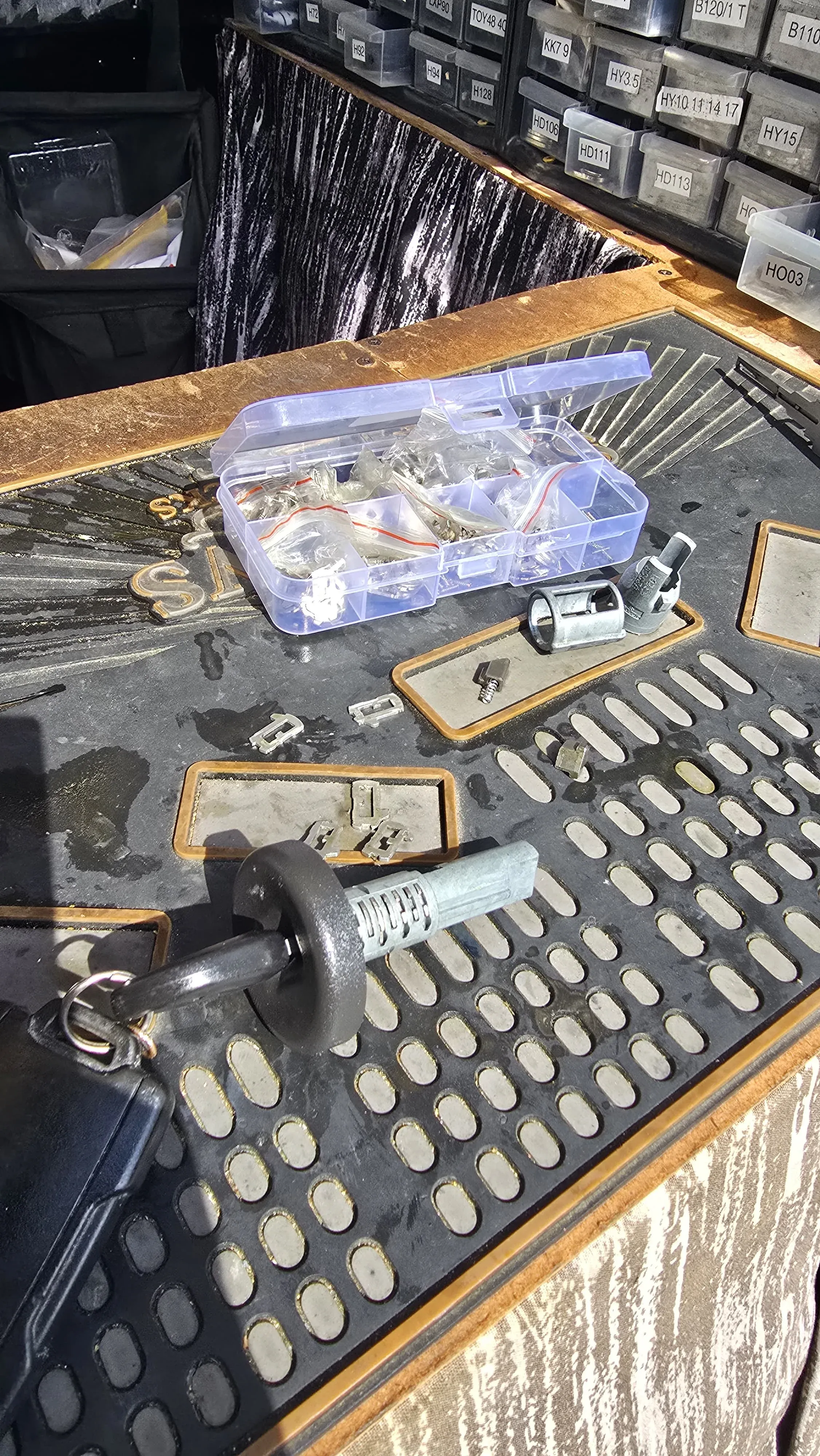An in-van key-cutting workstation with organized key blank storage bins