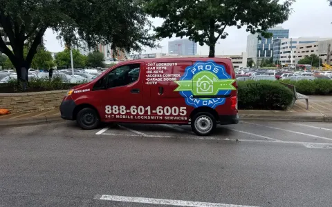 Pros On Call red Nissan NV200 service van parked at an Austin TX medical complex for a 24-hour emergency locksmith call