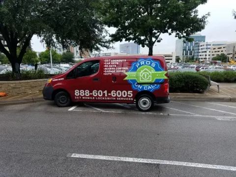 Pros On Call red Nissan NV200 service van parked at an Austin TX medical complex for a 24-hour emergency locksmith call