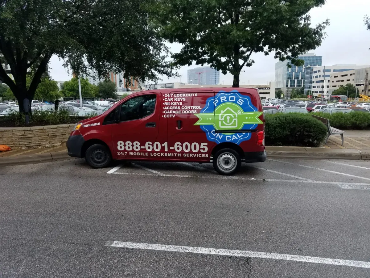 Pros On Call red Nissan NV200 service van parked at an Austin TX medical complex for a 24-hour emergency locksmith call