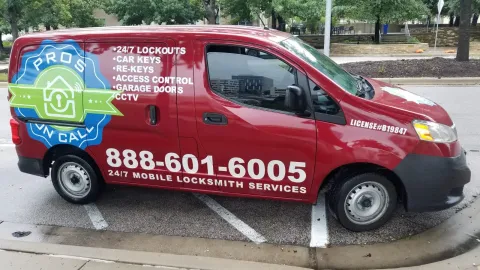 Side panel of a Pros On Call red Nissan NV200 service van listing locksmith services in Austin TX