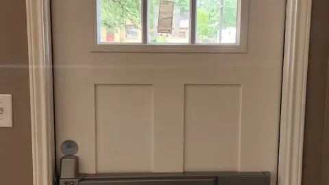 Commercial door with panic bar and door closer installed by Pros On Call in Austin TX, ADA compliant hardware