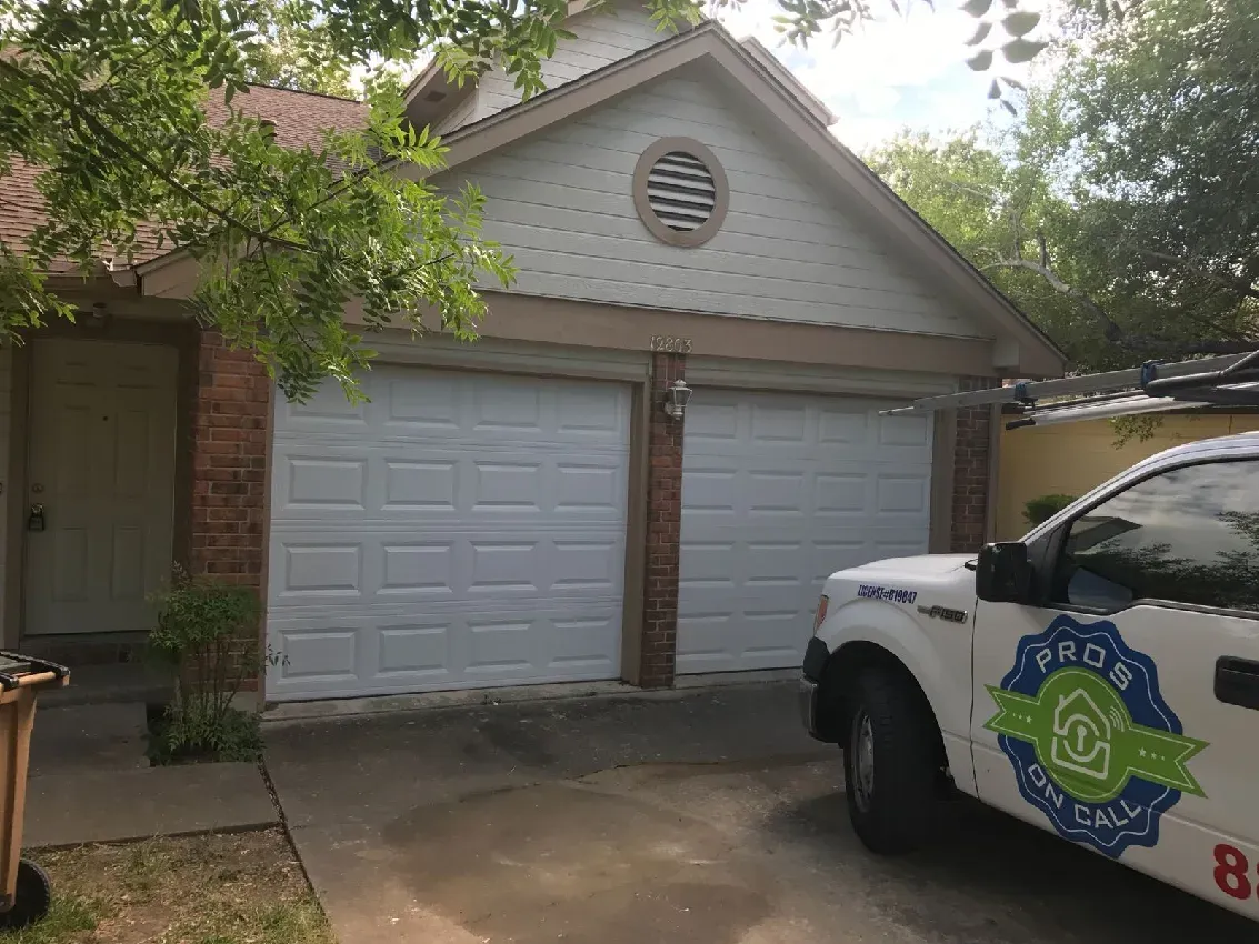White two-car garage door newly installed in Austin residential neighborhood by Pros On Call