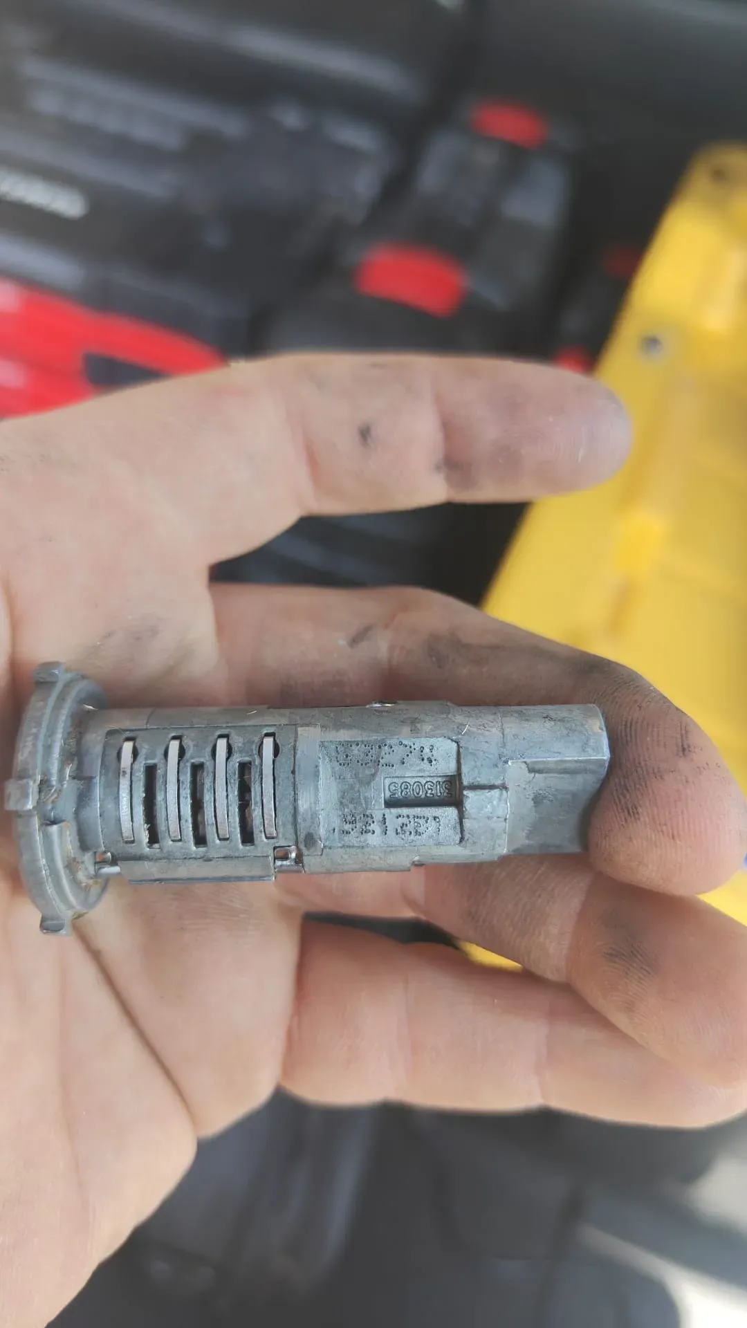 Pros On Call locksmith disassembling an ignition cylinder as part of automotive key service