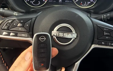 Pros On Call locksmith handling a Nissan smart key fob during a replacement service in Austin TX