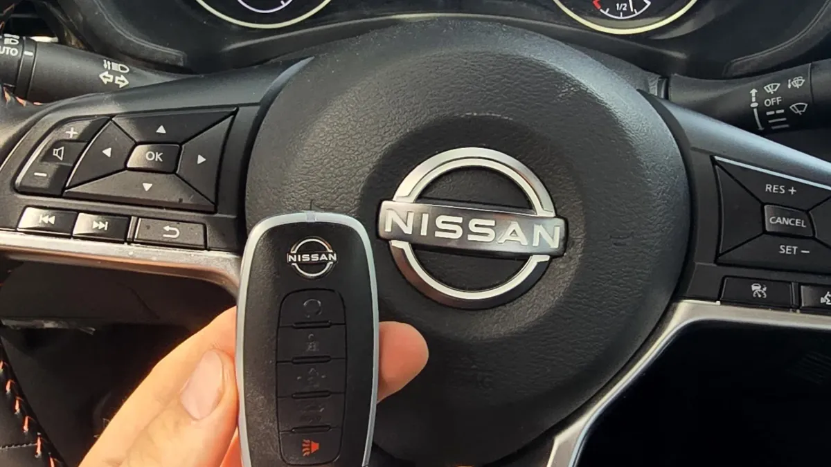 Pros On Call locksmith handling a Nissan smart key fob during a replacement service in Austin TX