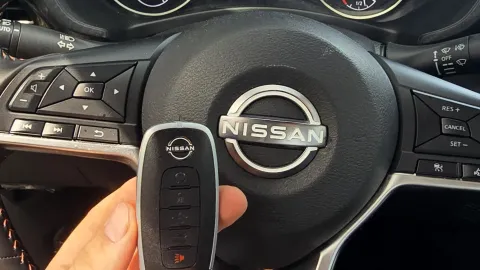 Pros On Call locksmith handling a Nissan smart key fob during a replacement service in Austin TX