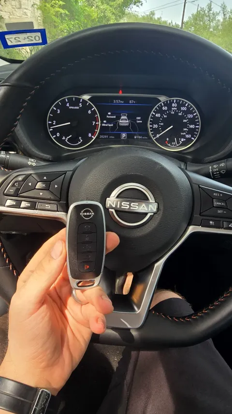 Pros On Call locksmith handling a Nissan smart key fob during a replacement service in Austin TX