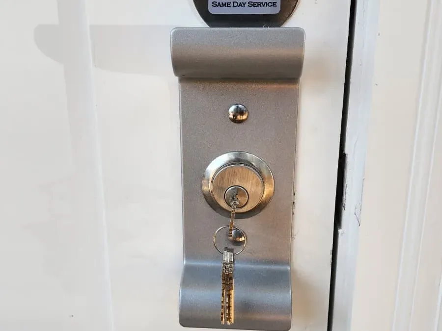 Pros On Call service sticker applied after barrel lock and key service at an Austin TX property, showing a verified and trusted locksmith completed the job