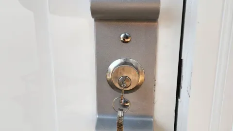 Pros On Call service sticker applied after barrel lock and key service at an Austin TX property, showing a verified and trusted locksmith completed the job