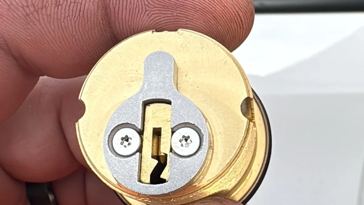 Brass mortise cylinder for a commercial door lock, showing the specialized hardware used by Pros On Call commercial locksmiths in Austin TX