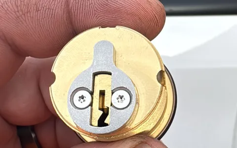 Brass mortise cylinder for a commercial door lock, showing the specialized hardware used by Pros On Call commercial locksmiths in Austin TX