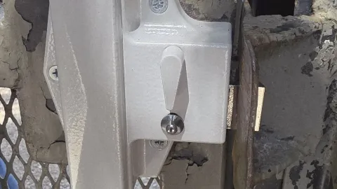 Gate latch hardware on a chain-link fence gate serviced by Pros On Call in Austin TX, a common residential gate repair component