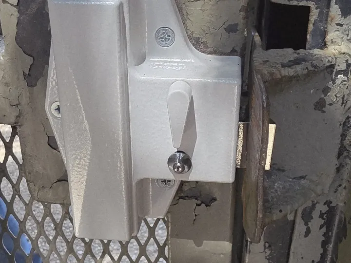 Chain link commercial gate latch hardware serviced by Pros On Call in Texas, representative of the entry hardware serviced at apartment properties.