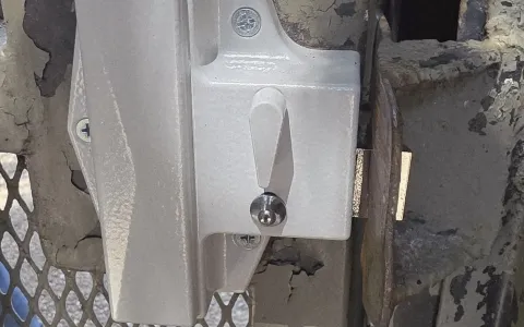 Gate latch hardware on a chain-link fence gate serviced by Pros On Call in Austin TX, a common residential gate repair component