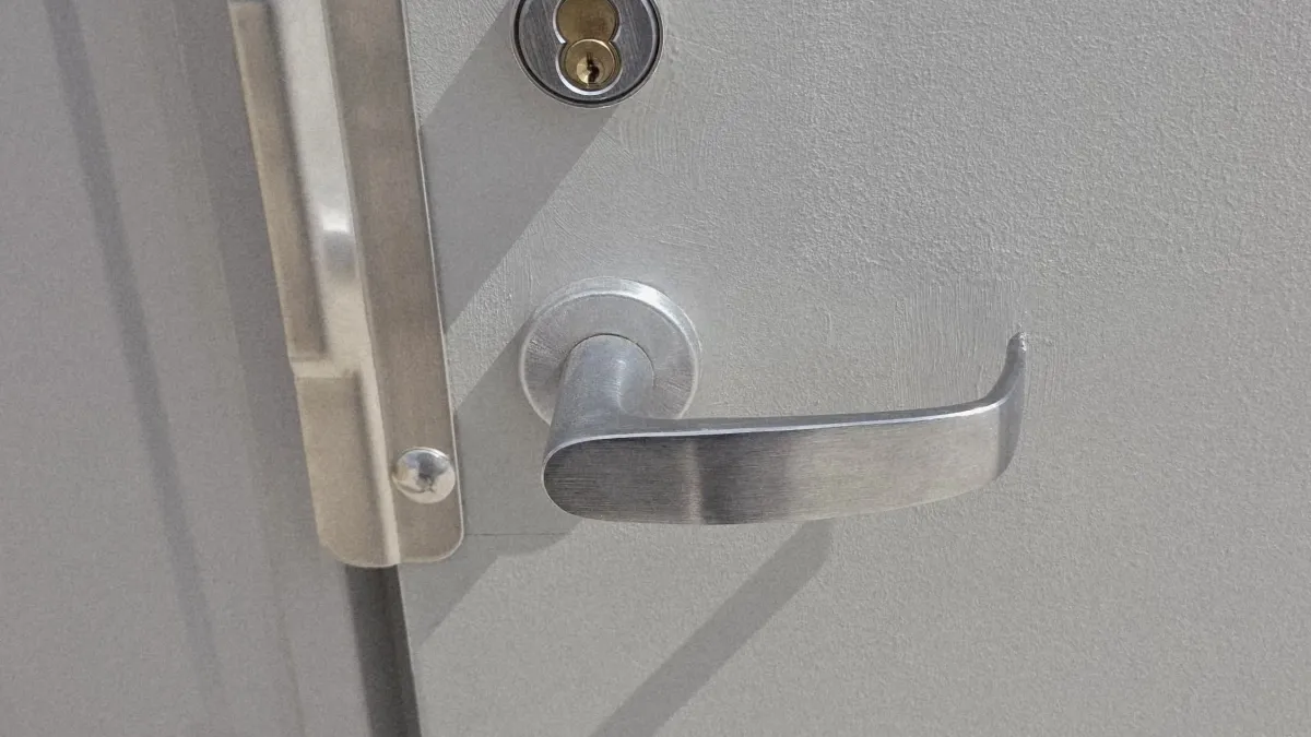 Commercial lever handle and deadbolt on a grey office door in Austin TX, a common business lockout scenario