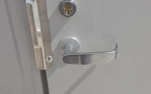 Commercial lever handle and deadbolt on a grey office door in Austin TX, a common business lockout scenario