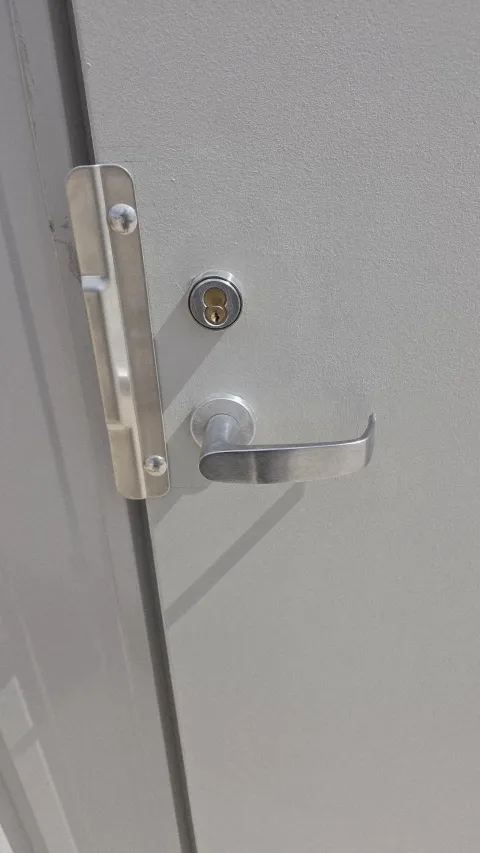 Commercial lever handle and deadbolt on a grey office door in Austin TX, a common business lockout scenario