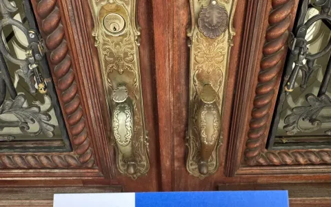 Ornate brass deadbolts on a double-door residential property in Austin TX, showing lock hardware required under Texas property code