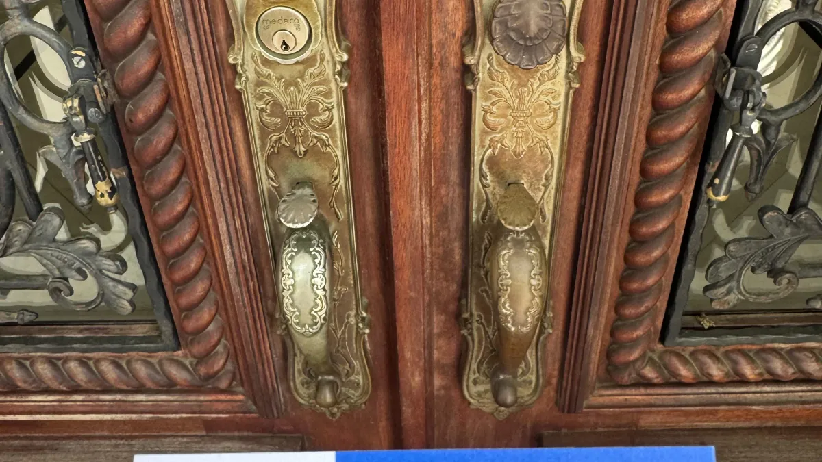 Ornate brass deadbolts on a double-door residential property in Austin TX, showing lock hardware required under Texas property code