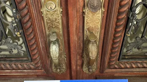 Ornate brass deadbolts on a double-door residential property in Austin TX, showing lock hardware required under Texas property code
