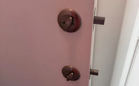 Pros On Call residential locksmith at an Austin TX home doorway assisting a homeowner who was locked out