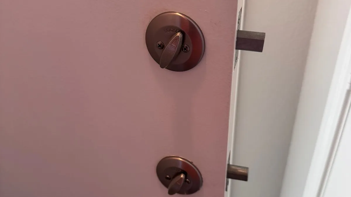 Pros On Call residential locksmith at an Austin TX home doorway assisting a homeowner who was locked out