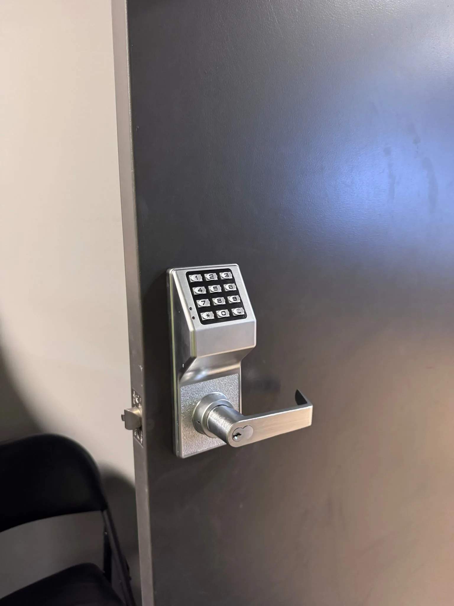 Alarm Lock DL2700 keypad installed on a dark commercial door by Pros On Call access control technician