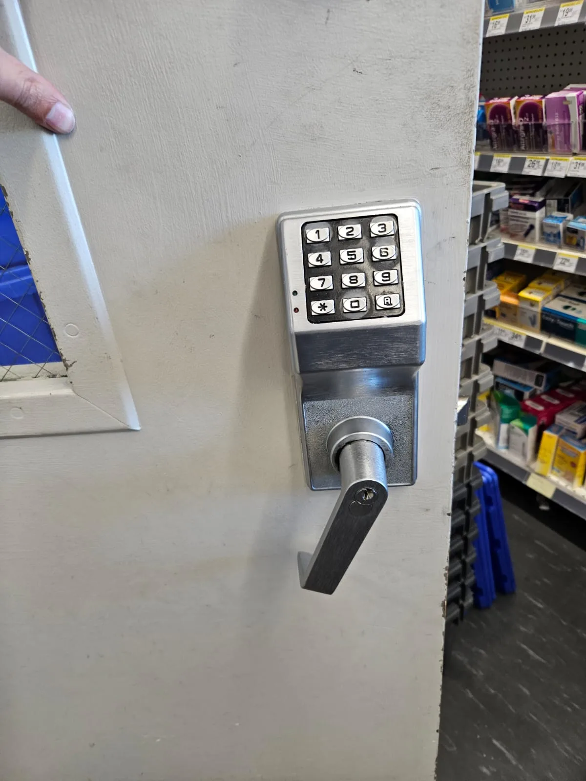 Alarm Lock electronic keypad and lever handle on white commercial door at pharmacy, Dallas commercial locksmith work by Pros On Call