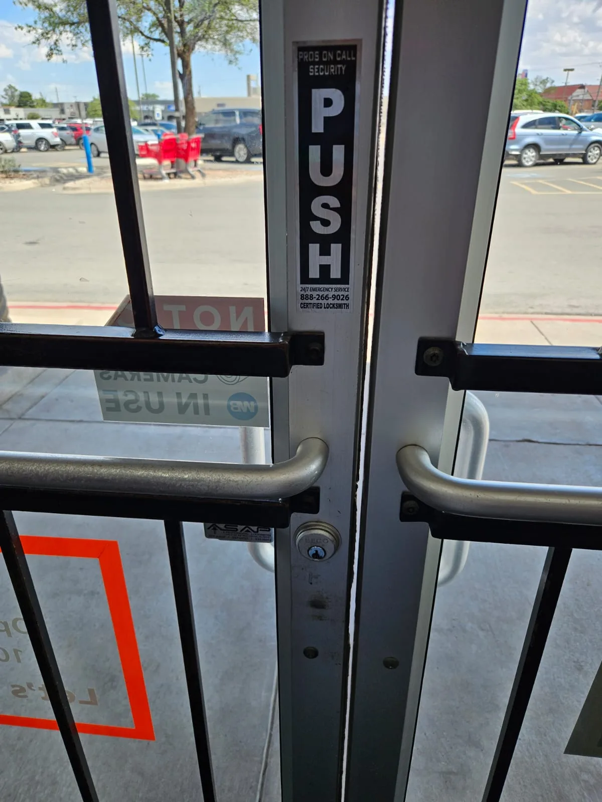 Pros On Call POC PUSH sticker on commercial glass door at Houston area business