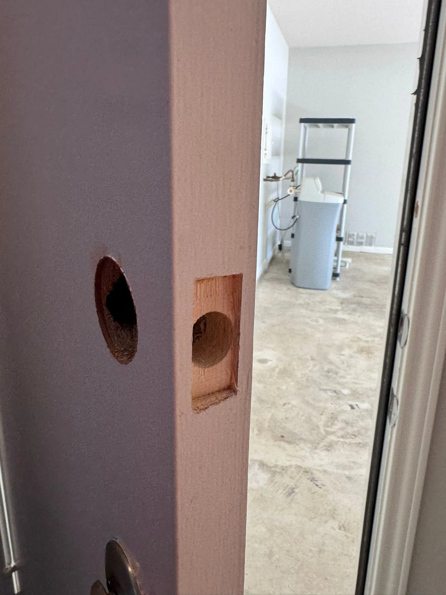 Residential door bored for lock installation showing the lock-fitting process by Pros On Call