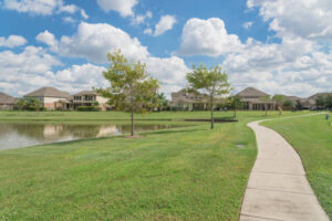 Walking pathway alongside leads to residential houses by the lake in Pearland, Texas, USA.