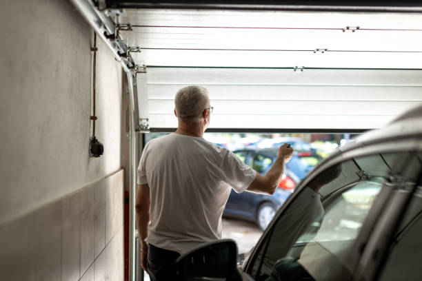 Man with eyeglasses closing and opening garage door with remote controller installed by Pros on call, best service for garage door repair & installation Plano TX