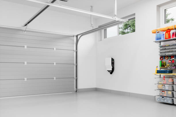 Interior of an empty modern residential garage with EV charger For best services for Door Repair and Installation Corpus Christi TX choose Pros on Call