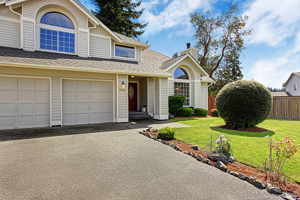 Luxury house exterior with tile roof. House with garage and front yard landscape