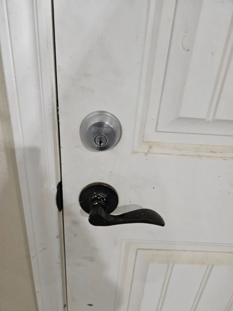 Residential White Door with Black Door Knob, and Deadbolt Lock installed by Reisdential Locksmith in New Braunfels TX