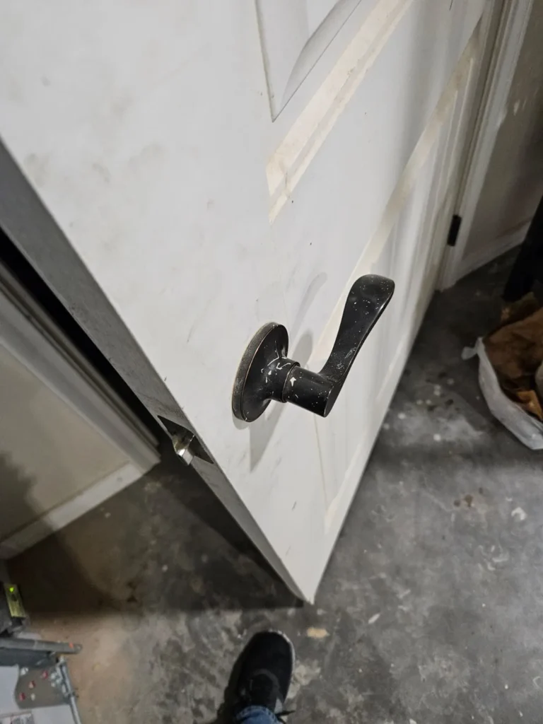 Residential White Door with Black Door Knob, and Deadbolt Lock installed by Residential Locksmith in South Austin TX